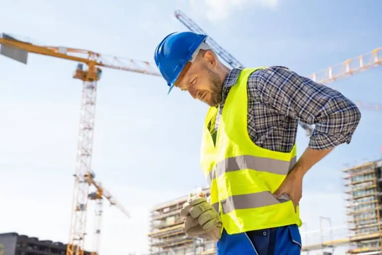construction worker holding back in pain