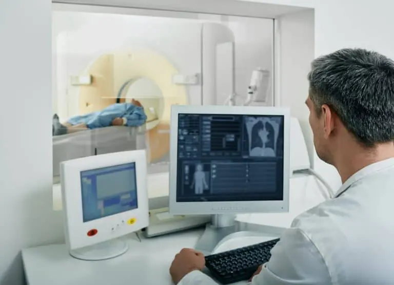 doctor looking at ct scan results on a computer