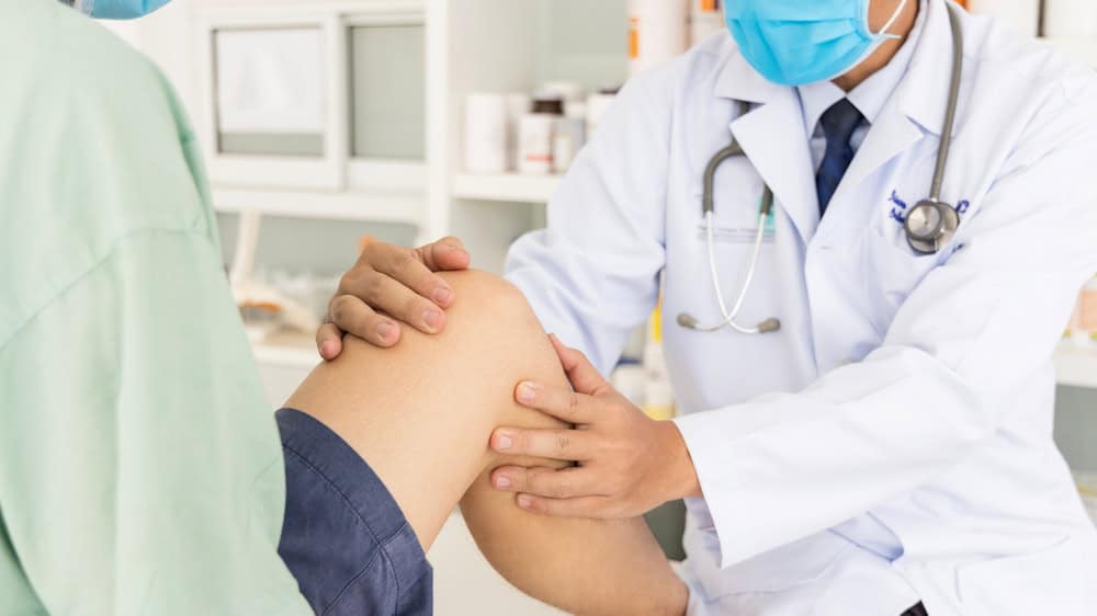 doctor working on a person's knee